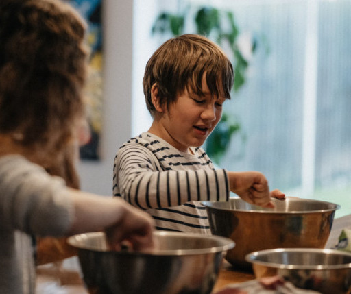 photograph of two children cooking in a kitchen